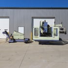 Takumi Seiki #V-11A, 3-Axis CNC vertical machining center w/4th-Axis 3PH & conveyor, 43.3" X, 21.6" Y, 25.5" - Image 1