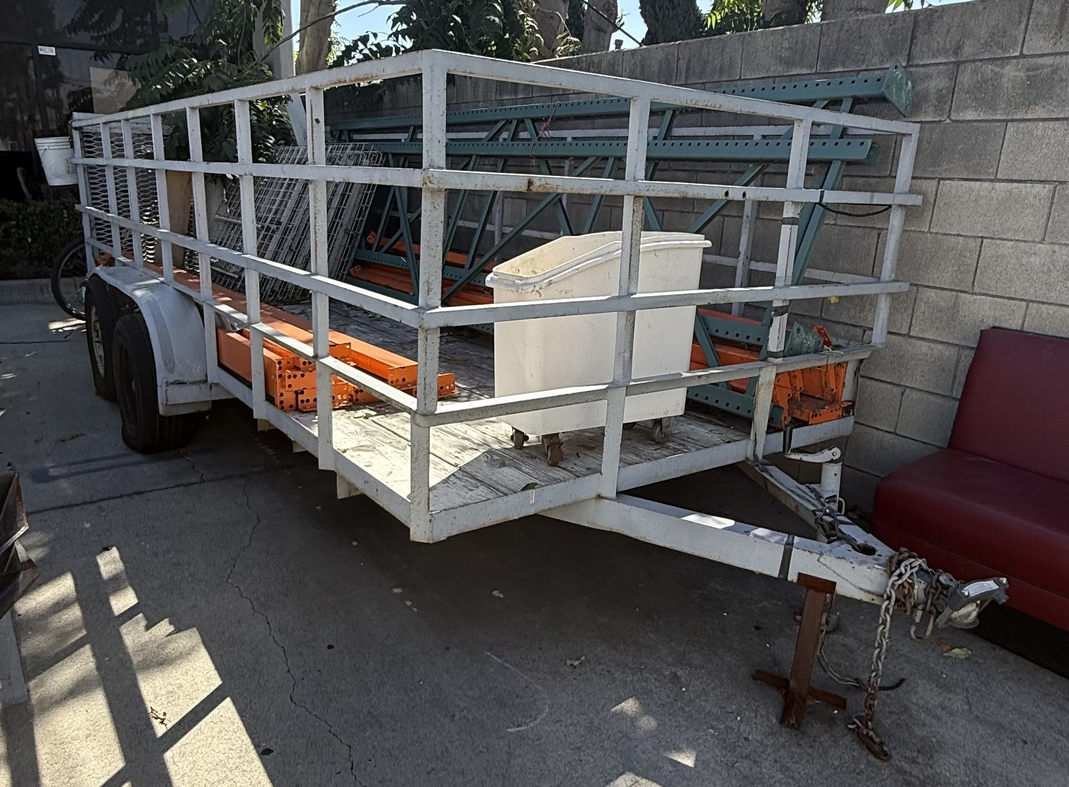 Tandem Axle Open Utility Trailer, steel tubular side rails, expanded metal rear gate/ramp, wood plank deck