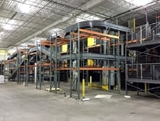 Bushman complete distribution conveyor system, 2 rows of 176' of pallet racking & supports, stairs, structure