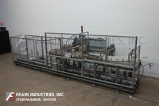 Hartness #825, automatic, intermittent motion, ascending, drop case packer rated from 10-30 cases per minute