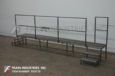 Stainless Steel mezzanine, equipped with a 180" x 24" standing platform set 24" off the ground, (2) step