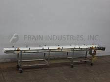 13" wide x 17.2' long, Tri-Mach, Stainless Steel table top conveyor, mounted on locking casters