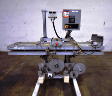 Roser Products, bottom fed labeler, includes conveyor to pass product thru bottom mounted labeling head