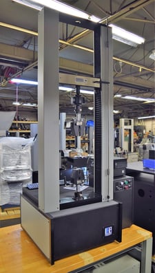 5625 lbf. MTS #QTest-25, tensile tester, 48" opening, 16" btwn screws, 48" stroke, 16" x 4" table