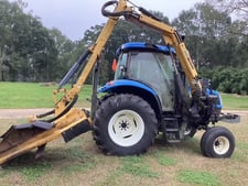 New Holland Ltd TS100, tractor with side bush hog