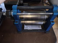 Precision, dual-roller calendaring press, graphite rollers, synchronized geared roller system