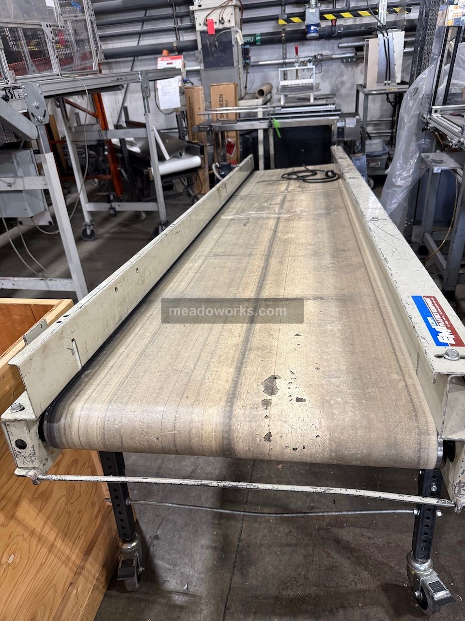 24" wide x 10' long, EMI #DD-24-10, Flat Belt Conveyor, 6.0 amps, adjustable-height legs on casters, side