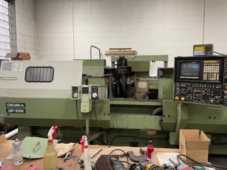 22.8" x 59" Okuma #GP-56N, CNC cylindrical grinder, 24" x10" x4" wheel, under power, good condition, 1993