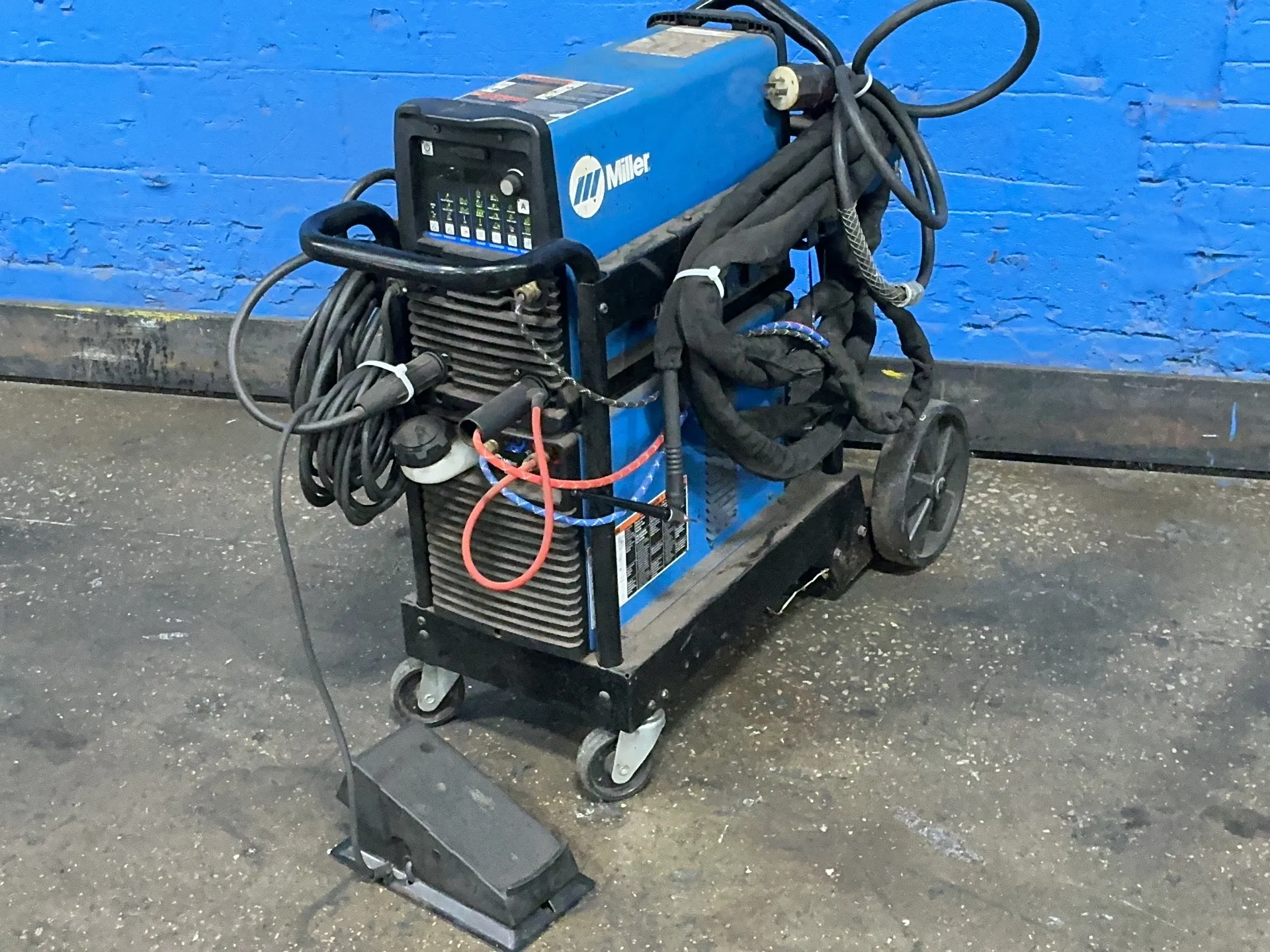 Miller #DYNASTY-210, welder, 210 Amps, 1.33 KW, foot pedal, 120-480 V., 1/3 Ph., 50/60 Hz.