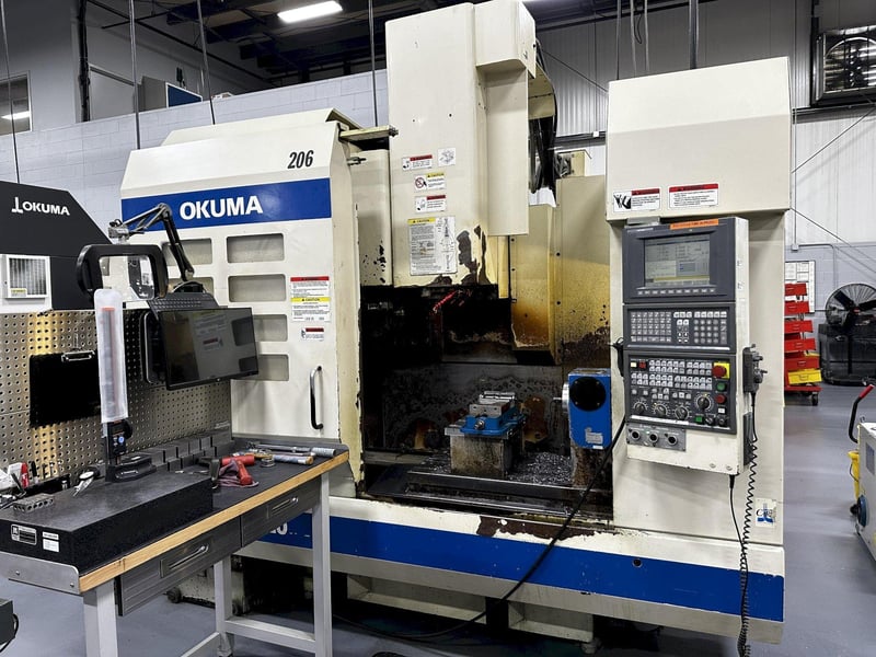 Okuma #MC-V4020, CNC vertical machining center, 20 automatic tool changer,  40 X, 20 Y, 17.7 Z, 15000 RPM, #40, 4-Axis, OSP-E100M, Kitagawa  TMX200BE5 4-Axis rotary table, chip conveyor, 2003 for Sale