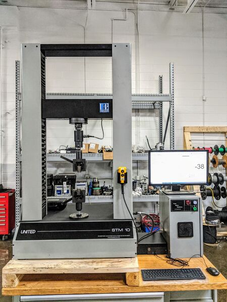10000 lbf. (50kN) United #STM-10, 42" tension & compression testing opening, 42" stroke, 22" x 6" table