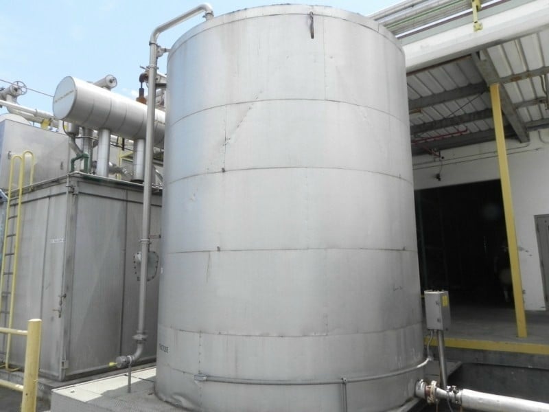 6000 gallon Carbon Steel Storage Tank, Epoxy, Jkt, 9'10" diameter x 12' high, 3" diameter side bottom outlet - Image 1