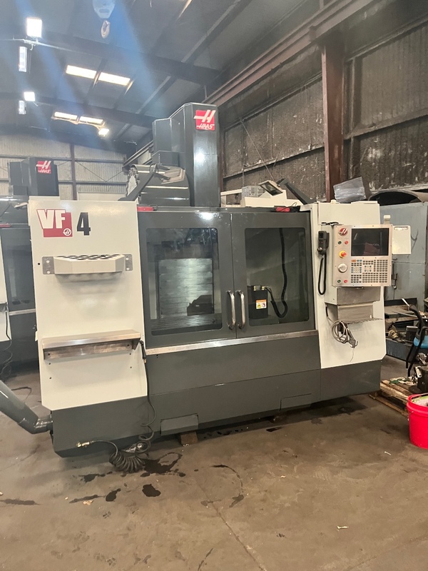Haas VF-4 vertical machining center with enclosure and control