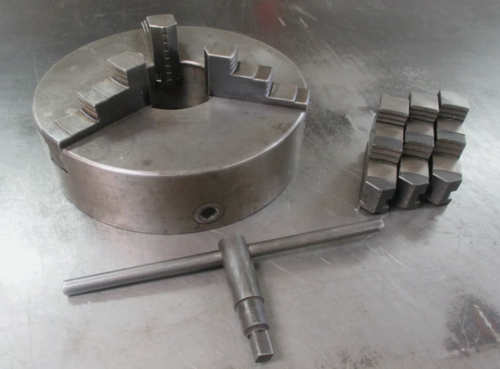12" 3-Jaw universal flat back lathe chuck with ID & outside dimension jaws & wrench - Image 1